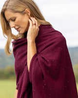 Model wearing Radiant Cashmere Sequin Wrap in burgundy