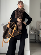 Samantha Brown, stylist wearing cashmere wrap coat in black with cashmere leopard print scarf