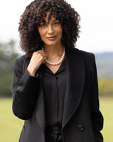 Close up of model wearing Cashmere Belted Shawl Collar Long Coat with Pick Stitching in black