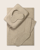 Cashmere eye mask, pouch, and socks in oatmeal on a light background