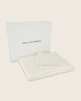 Cable knit baby blanket and pom-pom hat set in Ivory inside gift box