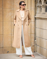 Model wearing sunglasses and Marceau Baby Camel Hair Trench Coat in camel