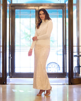 model wearing Pura Baby Cashmere Turtleneck Sweater in ivory and sequin skirt