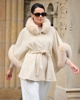 model walking wearing Frostmere Belted Cashmere Cape in oat