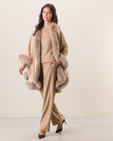 Woman wearing Fur Trimmed cashmere Cape in Blonde