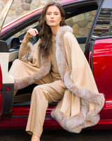Woman wearing Fur Trimmed cashmere Cape in Blonde