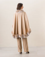 Woman Wearing Fur Trimmed cashmere Cape in Blonde