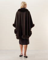 Woman Wearing Fur Trimmed cashmere Cape in Brown, back view
