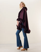 Woman Wearing Fur Trimmed cashmere Cape in plum