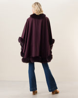 Woman Wearing Fur Trimmed cashmere Cape in plum