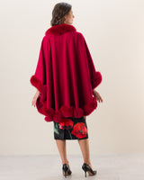 Woman wearing Fur Trimmed cashmere Cape in red