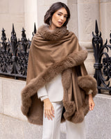 Woman wearing a Cervinia fur trim cape in Sable in an urban setting.