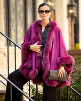 woman holding clutch on a stoop and wearing a berry cervinia