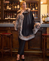 Woman wearing black multi silver fur trimmed cervinia standing in front of a bar
