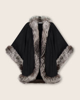 Black multi cape with fur trim on a beige background