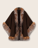 Brown multi cape with fur trim on a beige background