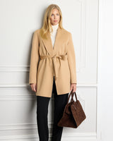 Sutton Double-Face Belted Car Coat in camel on model holding bag against a white wall