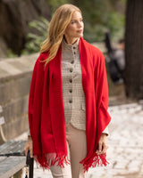Woman wearing Cashmere water weave wrap with fringe in red and business outfit outdoors