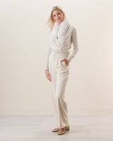 Woman wearing Wrap sweater with fur collar in Ivory