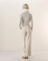 Woman wearing Wrap sweater with fur collar in Ivory