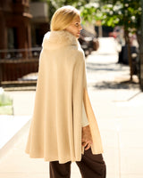 Model wearing Arden Cashmere Cape in oat, back view
