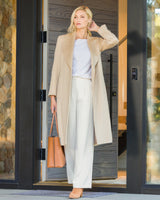 Woman in house entryway wearing Camel Hair Princess Coat in Blonde