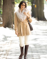 Woman wearing Alpaca Blend Wrap Short coat with Oversized Finland Fur Shawl Collar in Blonde, riding pants and boots on a street.