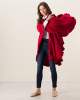 Woman Wearing Knitted Cashmere Cape in Red tossing over shoulder
