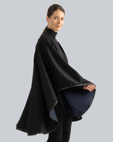 Woman Wearing Reversible Cashmere Cape with Leather trim in Blue/Black