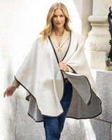 Woman wearing a Reversible Cashmere Cape with Leather trim in Oat/Grey in an urban setting