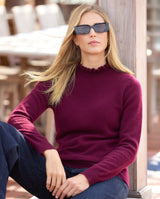 Model wearing sunglasses, jeans and Aveline Ruffle Mock Neck Cashmere Sweater in bordeaux