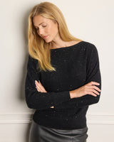 up close of a model wearing Stella Sequin Boat Neck Sweater in black