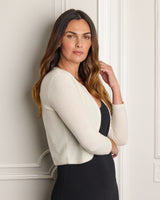 Side view of a model wearing Valentina Sequin Bolero Cardigan in white