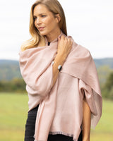 Cashmere Lurex and Sequin Wrap in dusty rose wrapped over her shoulder