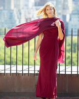 Woman in dress with a flowing Lightweight Cashmere Wrap in Bordeaux against a cityscape background