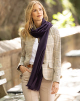 Woman wearing a plaid blazer, shirt, and Lightweight cashmere wrap in Dark Currant