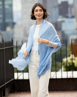 Woman wearing Lightweight Cashmere Wrap in Sky Blue over plain outfit