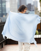 woman's back holding open Lightweight Cashmere Wrap in Sky Blue