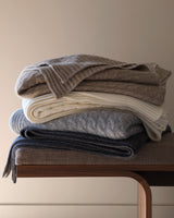 stack of Cable Knit cashmere Throws in Ivory