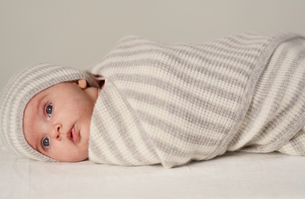 baby swadled in cashmere blanket