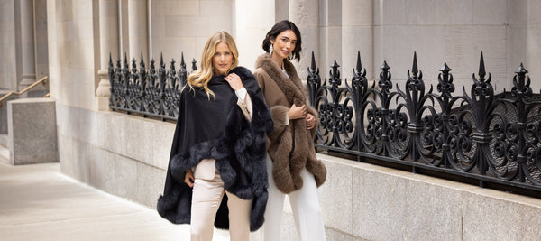 2 Models wearing fur trimmed cervinia capes on city street