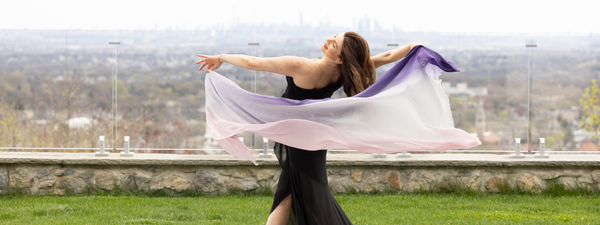 woman displaying purple ombre wrap while outside