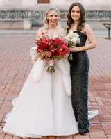 photo of bride and bridesmaid; bride wearing white cashmere fur trimmed capri shawl