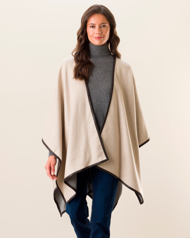 Woman Wearing Reversible Cashmere Cape with Leather Trim in Oat/grey
