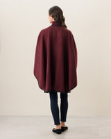 Woman Wearing Reversible Cashmere Cape with Leather trim in Deep Red/Charcoal