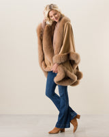 Woman Wearing Fur Trimmed Cape in camel