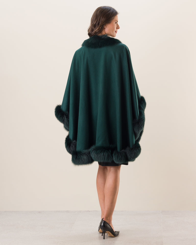 Woman Wearing Fur Trimmed Cape in Emerald