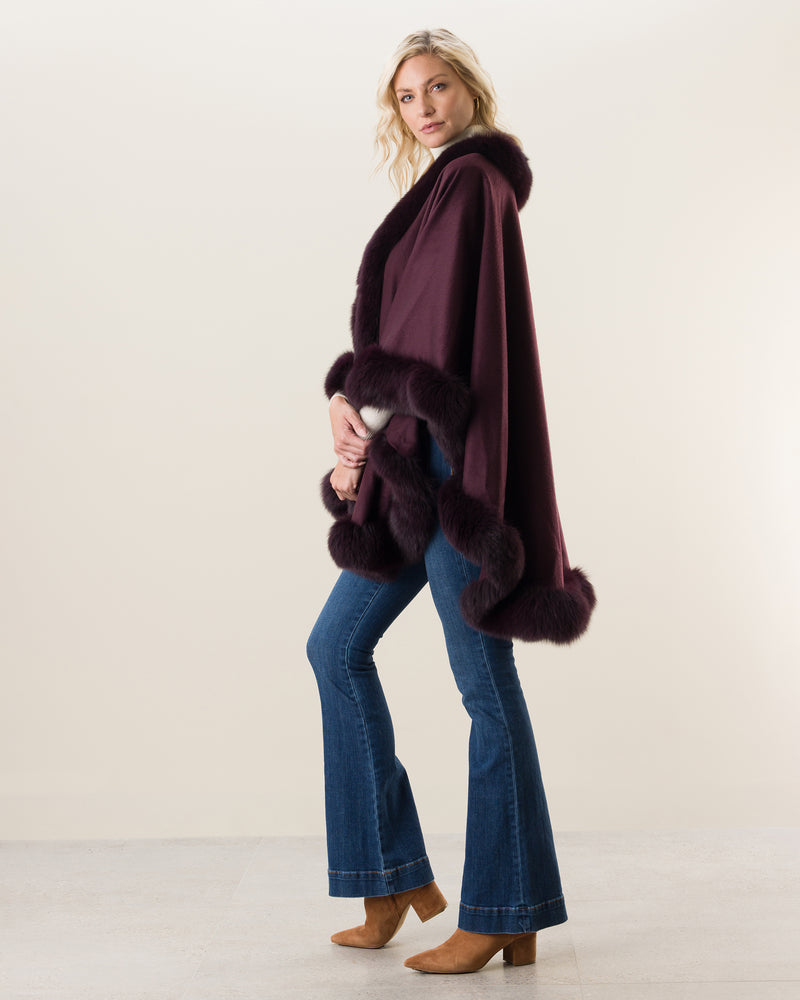 Woman Wearing Fur Trimmed Cape in plum