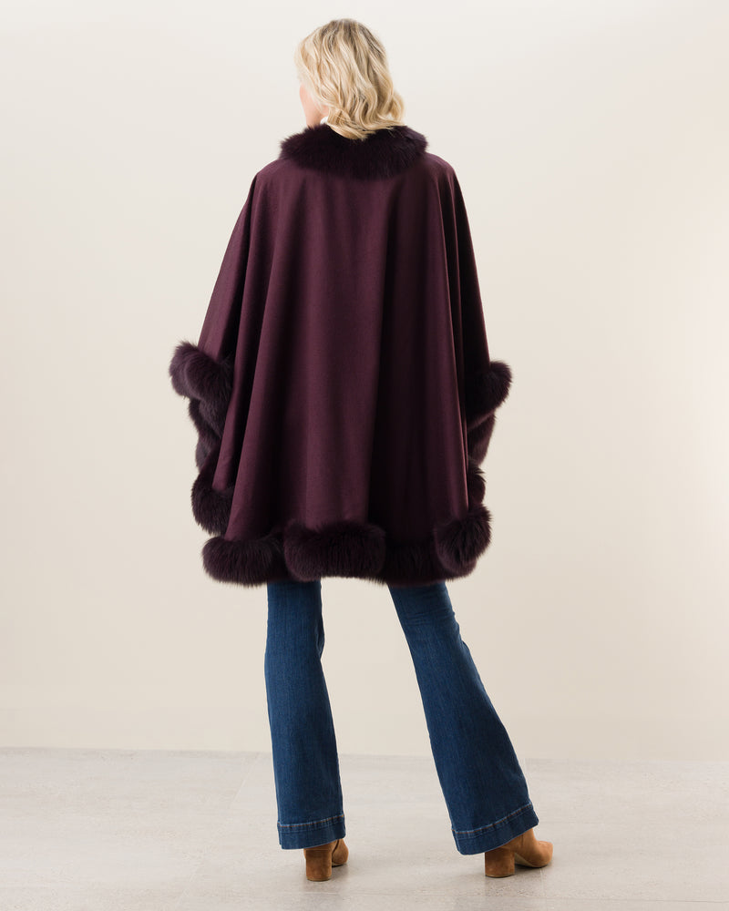 Woman Wearing Fur Trimmed Cape in plum