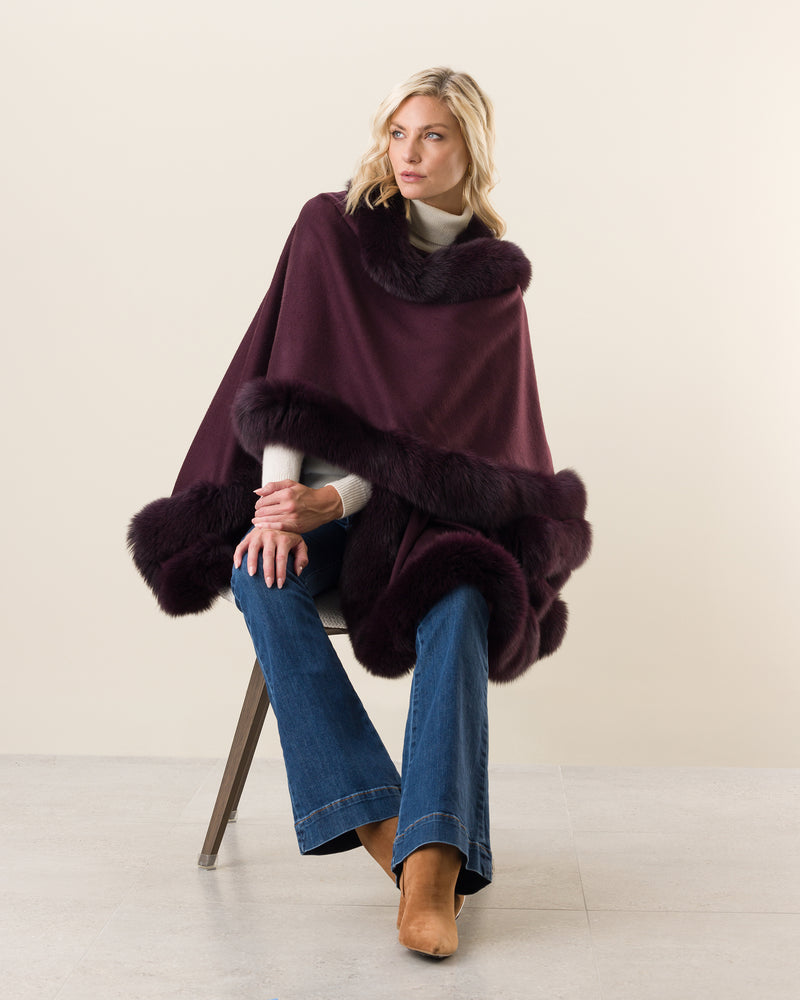 Woman Wearing Fur Trimmed Cape in plum
